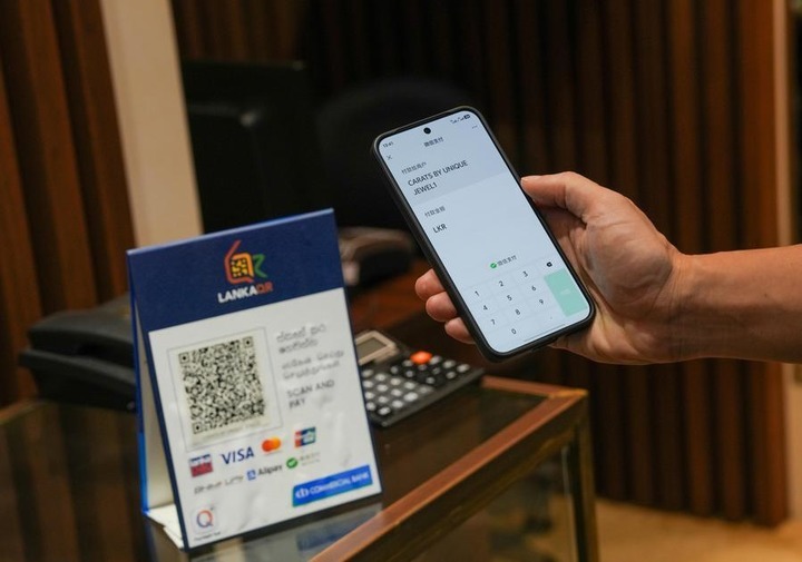 A customer makes a payment by scanning a local QR payment code with WeChat Pay at a shop in Colombo, Sri Lanka, April 23, 2026. (Photo by Thilina Kaluthotage/Xinhua)