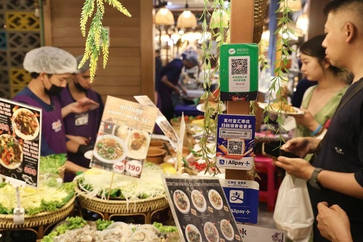 QR payment codes accepting WeChat Pay and Alipay are seen at a seafood booth in ICONSIAM shopping mall, Bangkok, Thailand, May 2, 2026. (Xinhua/Sun Weitong)