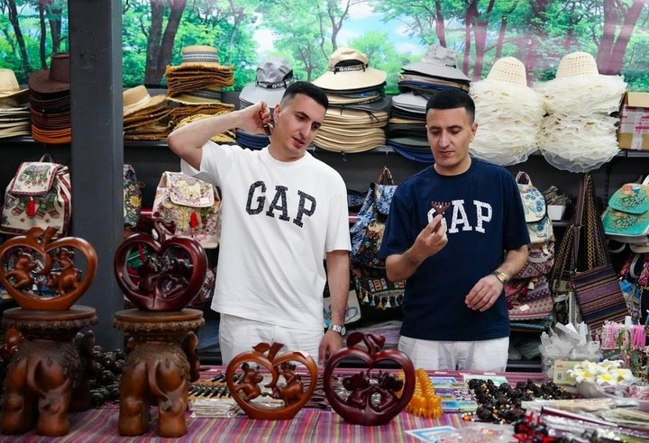 Han Shang (R) and Hu Sheng select handicrafts during an event held in Mojiang Hani Autonomous County, southwest China's Yunnan province, May 1, 2026. (Xinhua/Chen Xinbo) fd299866ad0ef830d91ab31012202a73.jpeg