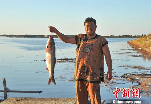 身着传统服饰的赫哲族人打渔场景。受访者供图 点击进入下一页