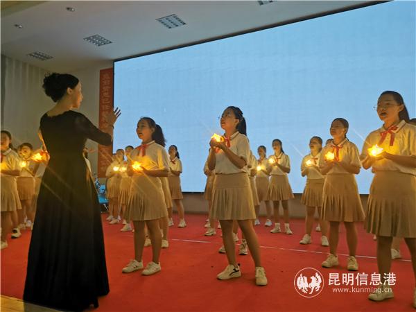 学生捧灯合唱。