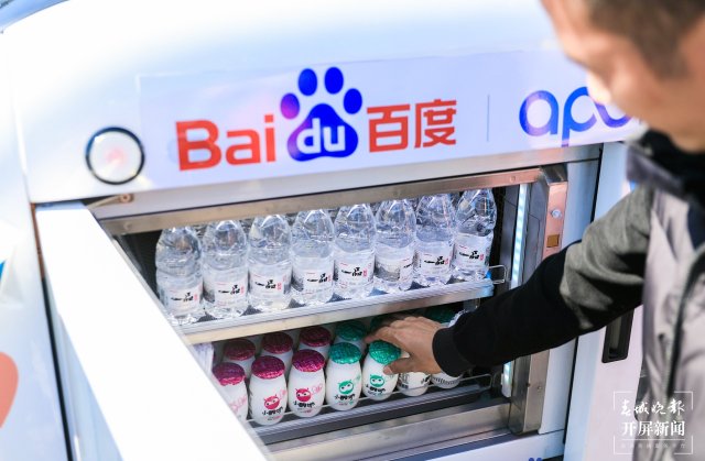 游客在百度智行自动售货机前扫码购买商品2.jpg