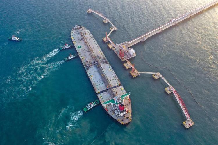 An aerial drone photo shows a vessel carrying 179,000 tonnes of petrochemical raw materials berthing at Yangpu Port in Danzhou, south China's Hainan Province, Dec. 18, 2025. (Xinhua/Guo Cheng)