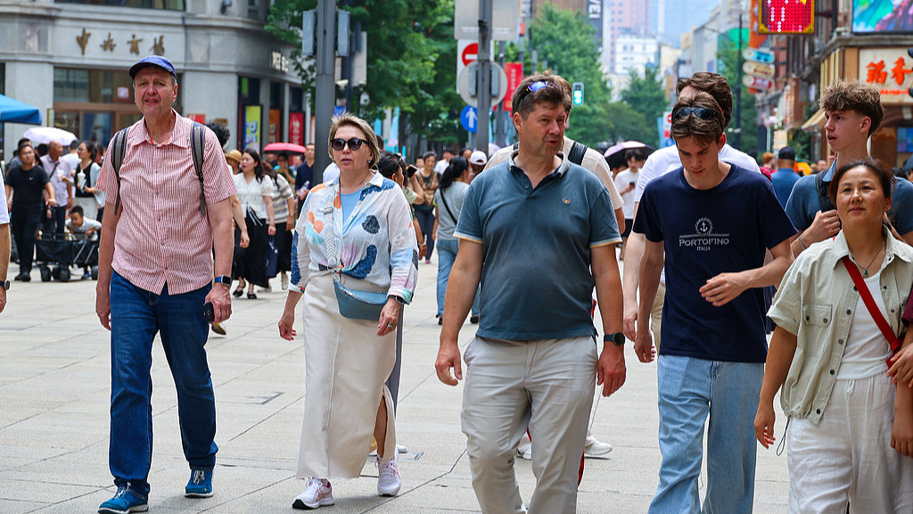 Foreign visitors walk along a pedestrian street in central Shanghai, China, June 27, 2026. /VCG